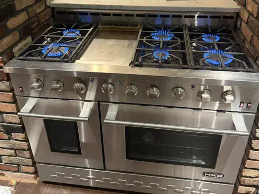 Gas cooktop burners lit after a repair