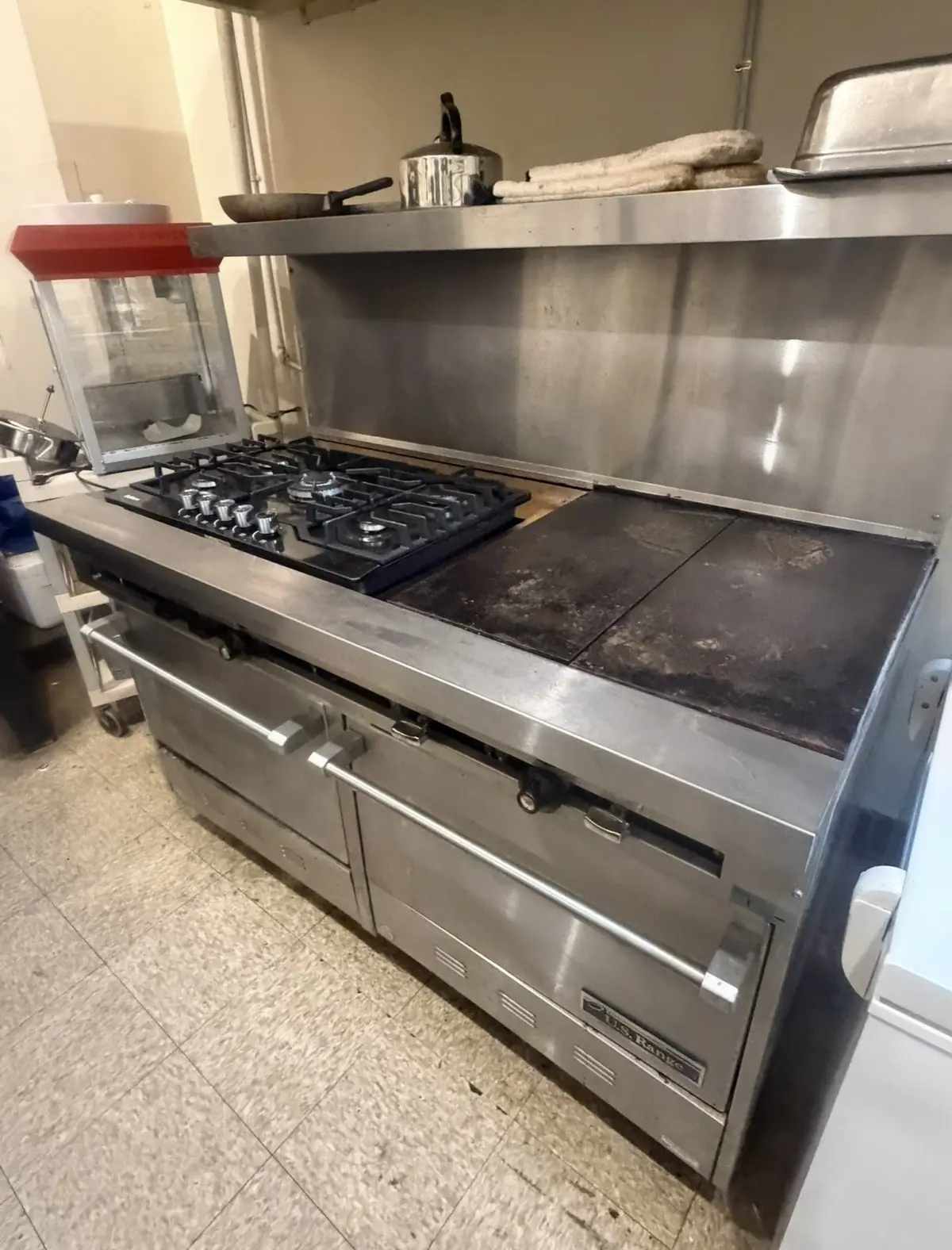 Commercial range with gas burners and a griddle