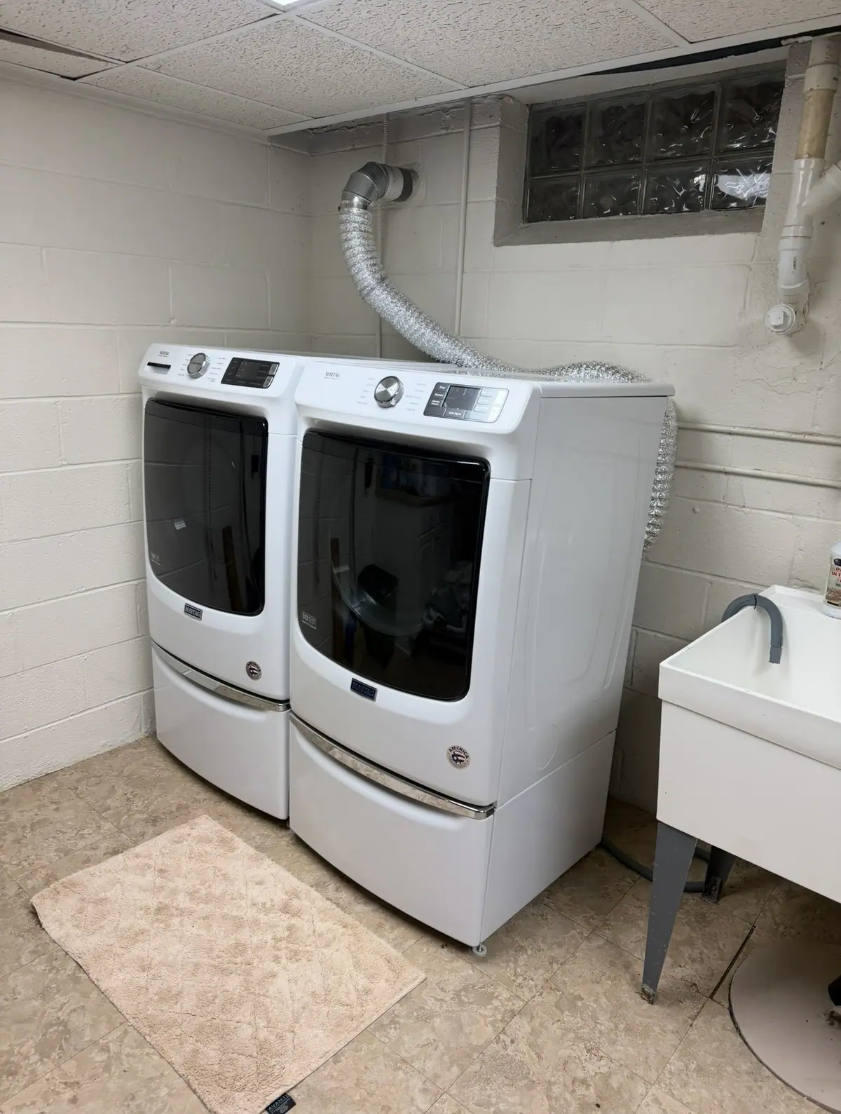 Front-load washer and dryer pair in a laundry room