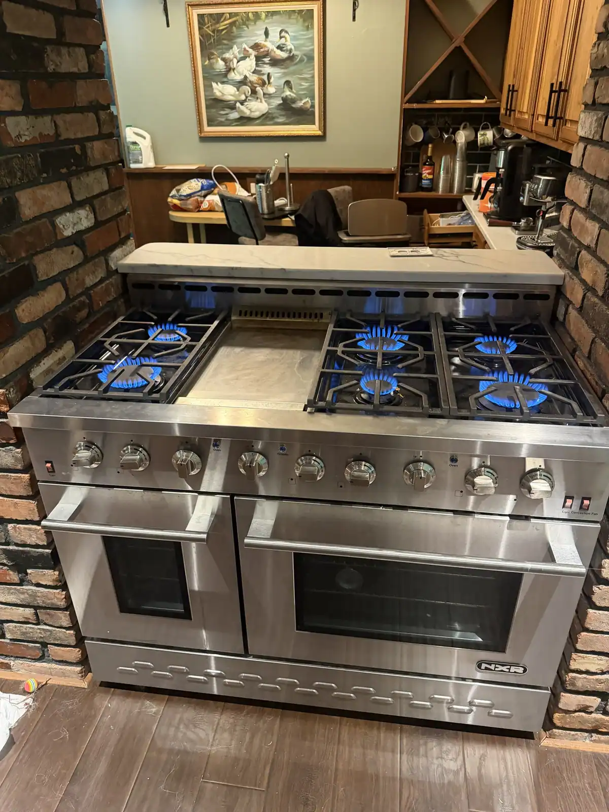 Gas range with lit burners during a service check