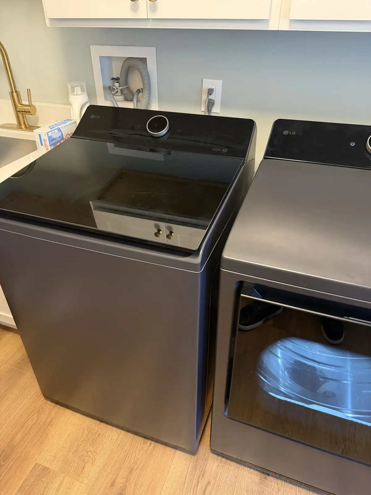 Top-load washer and matching dryer in a laundry room